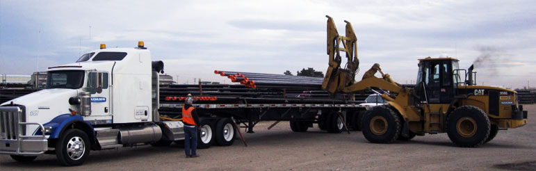 PIPE BEING LOADED ON A TRAILER SEMI TRUCK